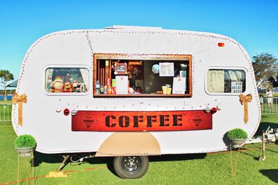 Campervan cafe parked on grassy field