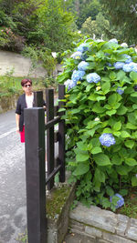 Portrait of woman standing by plants