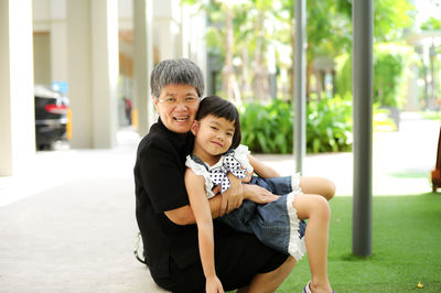 Portrait of smiling grandmother and granddaughter