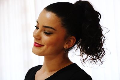 Close-up of smiling teenage girl with ponytail