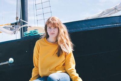 Portrait of smiling woman sitting on boat