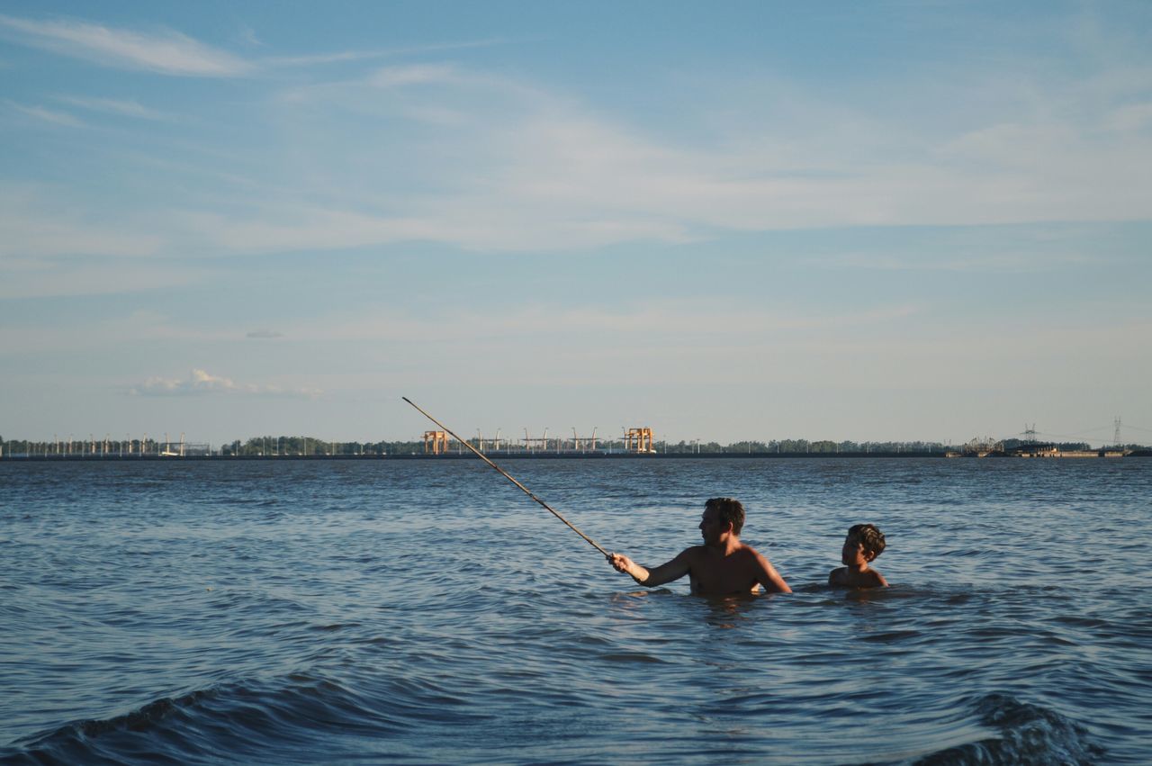 water, sea, waterfront, nautical vessel, leisure activity, lifestyles, sky, fishing, nature, men, boat, tranquility, beauty in nature, scenics, rippled, fishing rod, transportation, outdoors