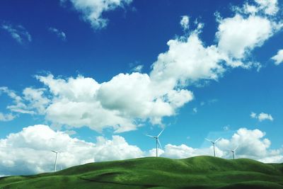 Scenic view of agricultural field against blue sky