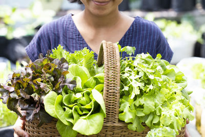 Midsection of woman holding flower