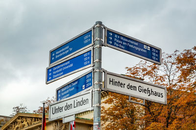 Low angle view of road sign against sky