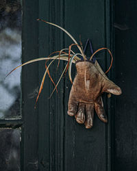 Close-up of stuffed toy hanging on metal wall