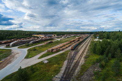 High angle view of road amidst field against sky