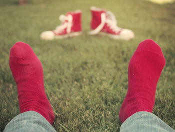 Low section of person standing on grassy field