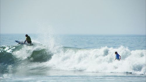 People surfing in sea