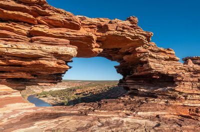 View of rock formations against clear blue sky