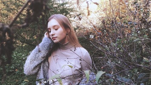 Young teenage girl standing in forest