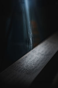 Close-up of spider web on table