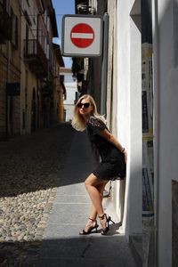 Portrait of young woman standing on street