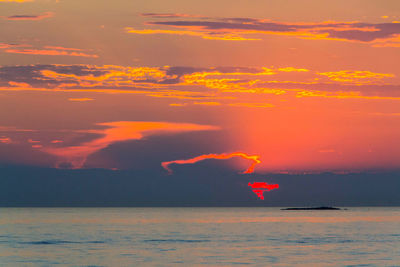 Scenic view of sea against orange sky