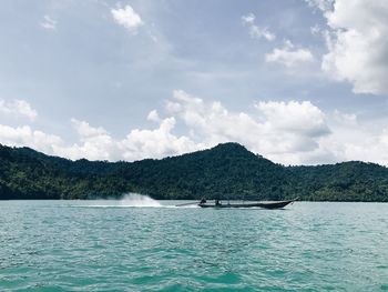 Scenic view of lake against cloudy sky