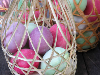 Close-up of colorful easter eggs in wicker basket on table