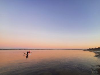 Scenic view of sea against clear sky during sunset