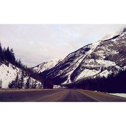 Scenic view of snow covered mountains against sky