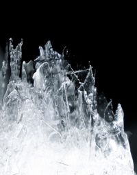 Close-up of water splashing over black background