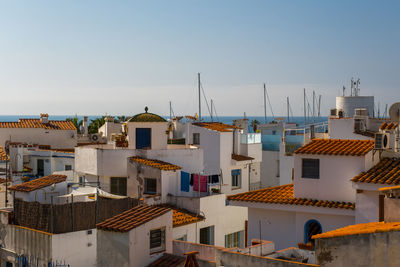 Buildings in city against clear sky