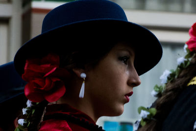 Side view of young woman wearing earring and hair accessory outdoors