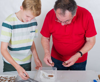 People making cookies on table at home