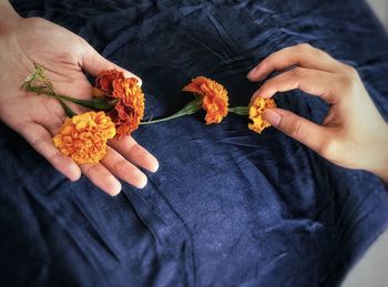 Midsection of person holding orange