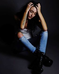 Portrait of a beautiful young woman sitting outdoors