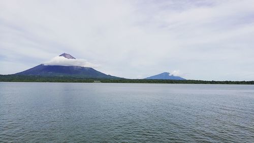 Scenic view of lake by mountain against sky