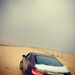 View of car on beach against sky