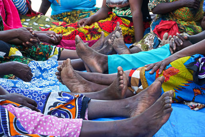 Low section of women in traditional clothing sitting outdoors