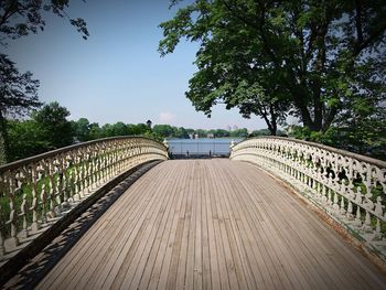 Footbridge over canal against sky