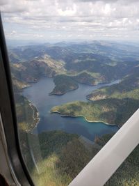 Aerial view of landscape seen through airplane window