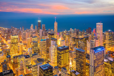 Aerial view of illuminated buildings in city