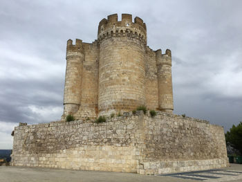 Old ruin building against cloudy sky