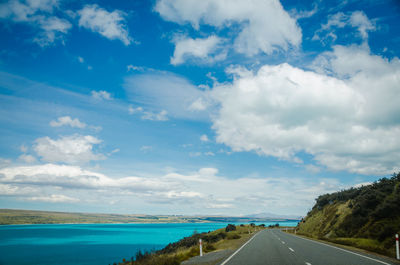 Road by sea against sky