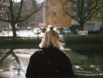 Rear view of woman on snow covered city