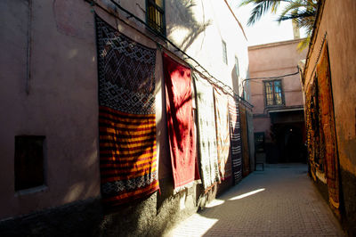 Clothes drying on alley amidst buildings