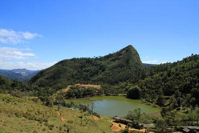 Scenic view of mountains against blue sky