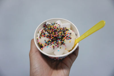 Close-up of hand holding ice cream