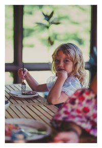 Portrait of a girl sitting on table