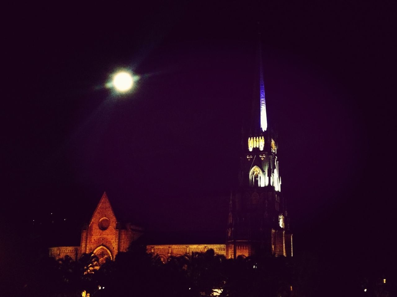 architecture, night, built structure, building exterior, illuminated, religion, low angle view, church, place of worship, spirituality, cathedral, sky, famous place, travel destinations, city, dark, clear sky, history