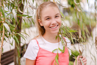 Portrait of smiling girl with plants
