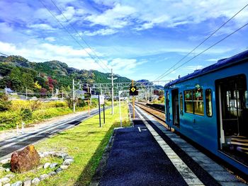 Train on railroad tracks against sky