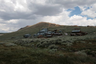 Abandoned house on field against sky