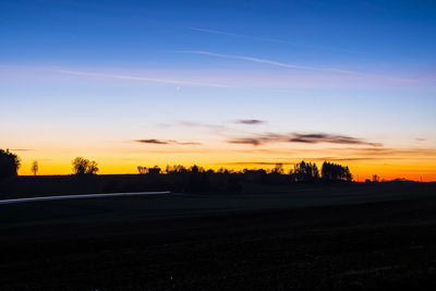 Silhouette trees against sky during sunset