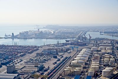 High angle view of buildings by river against clear sky