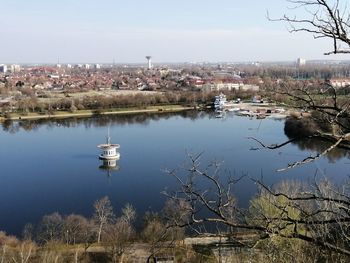 Scenic view of lake and buildings against sky