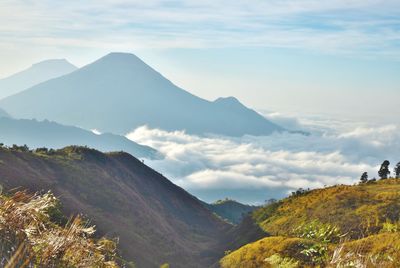 Scenic view of mountains against cloudy sky