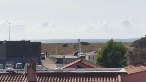 Panoramic view of buildings and sea against sky